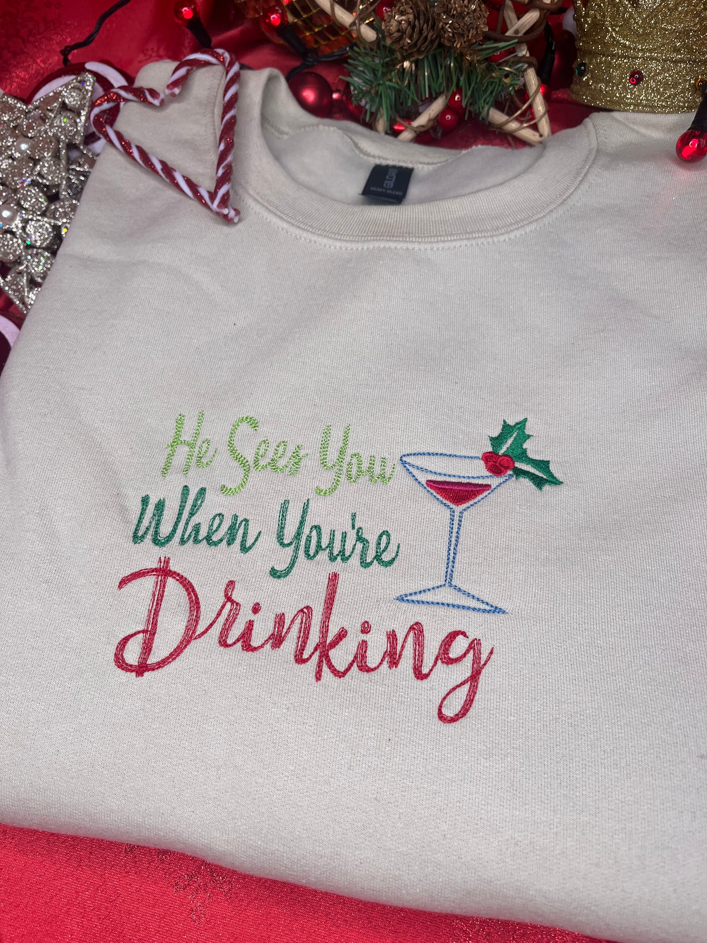 HE SEES YOU WHEN YOUR DRINKING EMBROIDERED SWEATSHIRT