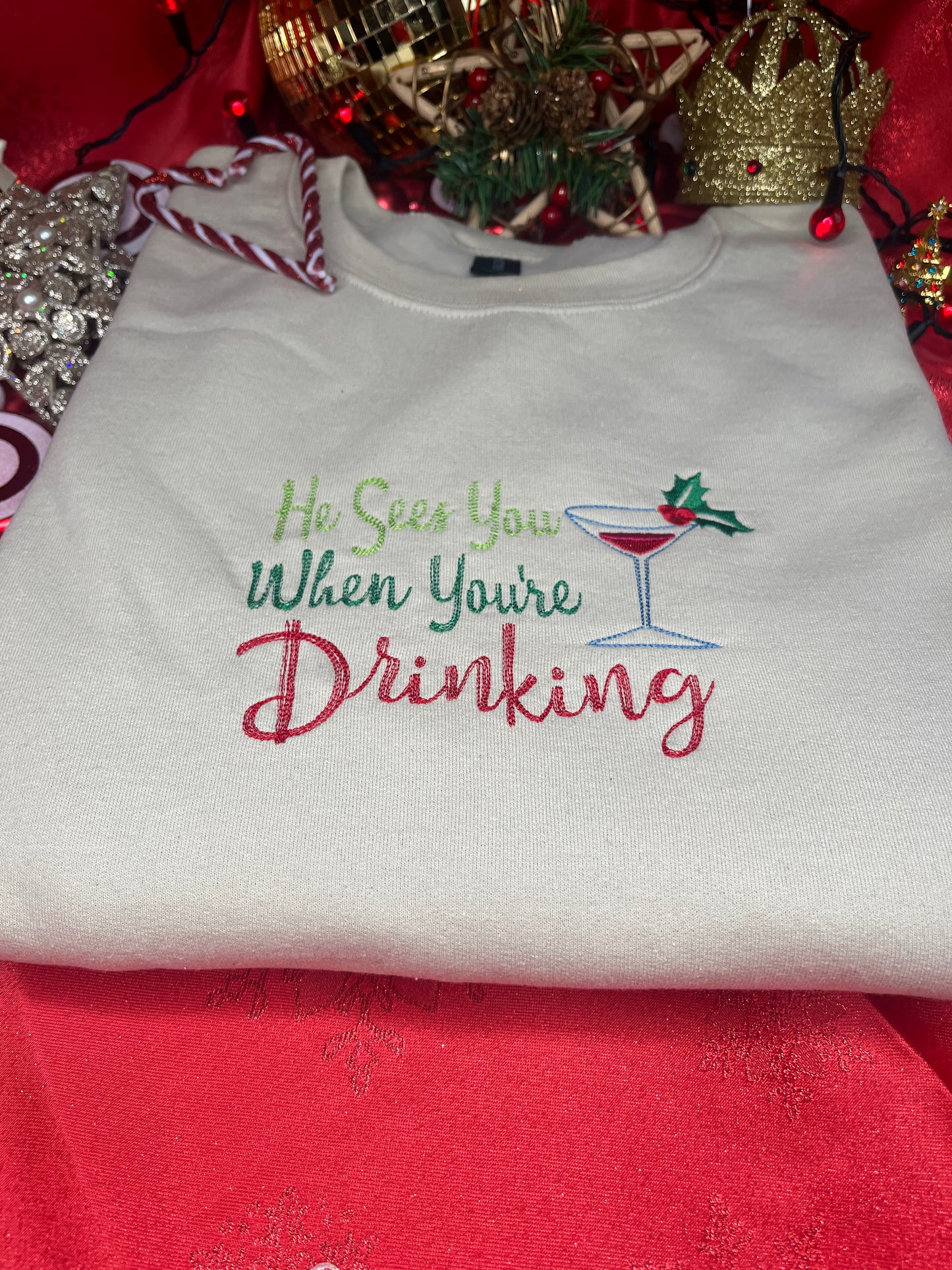 HE SEES YOU WHEN YOUR DRINKING EMBROIDERED SWEATSHIRT