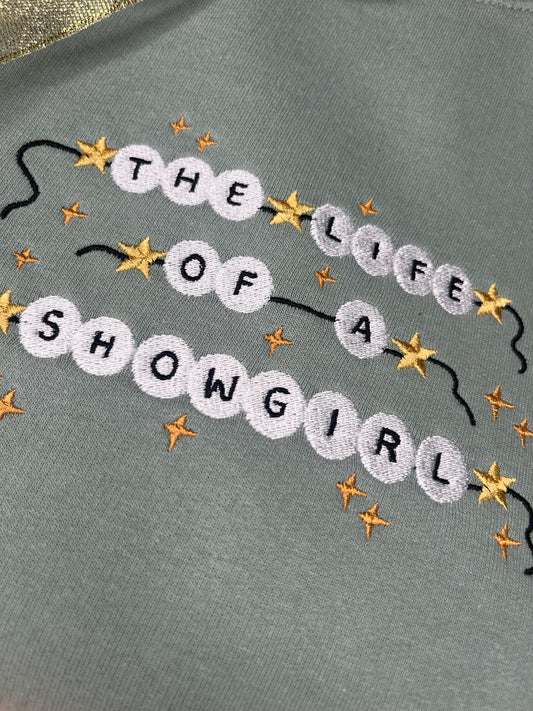 THE LIFE OF A SHOWGIRL EMBROIDERED SWEATSHIRT
